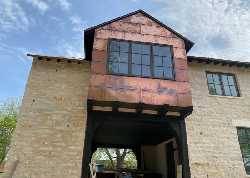 Copper metal panel facade on a stone building for Skylight Installation in El Centro